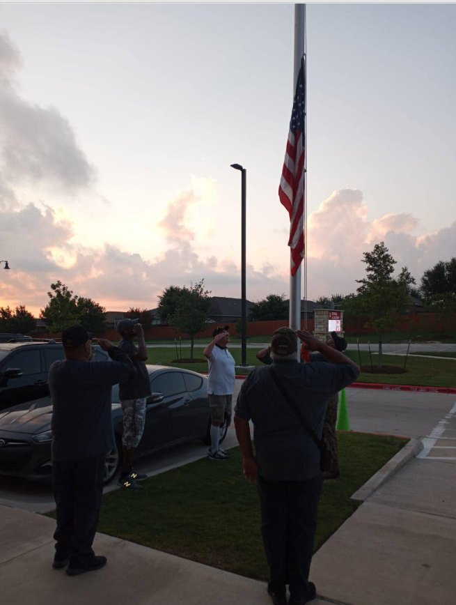 Members saluting during a flag ceremony